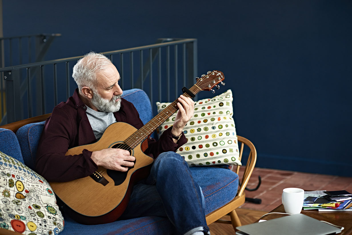 One Fell Swoop - senior man playing guitar